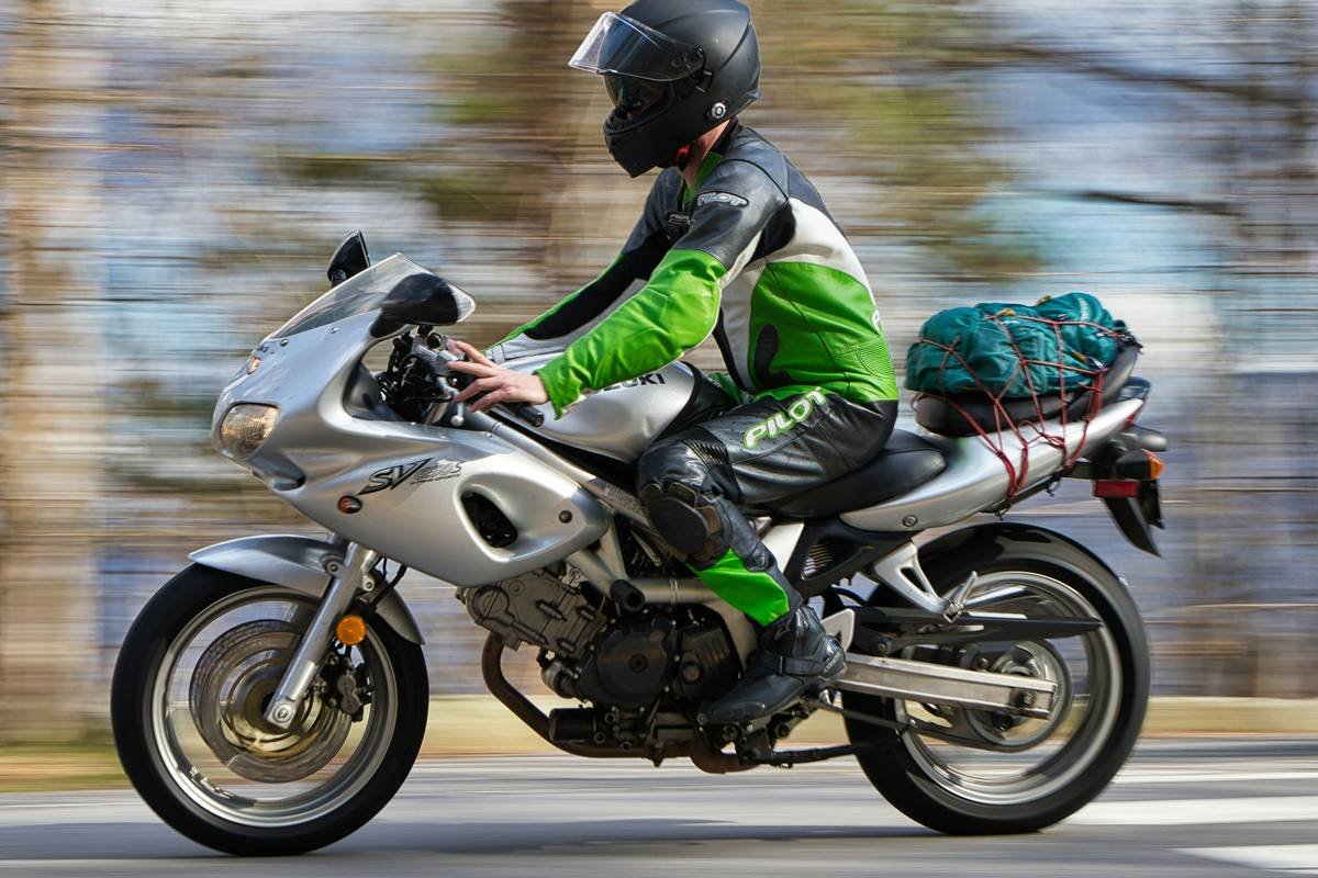 Infographic showing 78% of travel insurance policies exclude motorcycles over 125cc, with medical evacuation costs averaging $42,000 in Southeast Asia