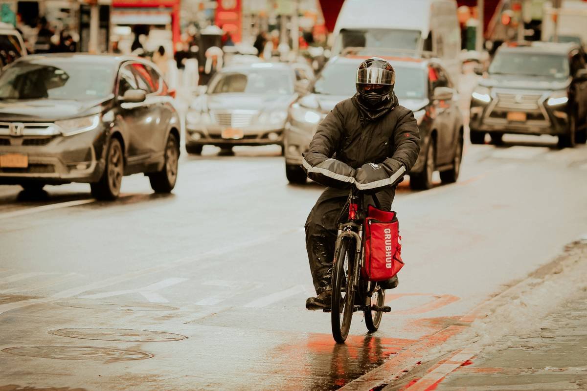 rider reviewing liability coverage new motorcycle policy on tablet while traveling