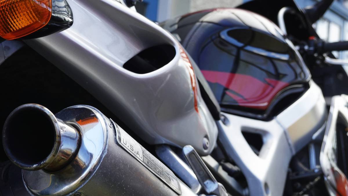 Close-up of heat shield for motorcycle installed on rental bike exhaust pipe